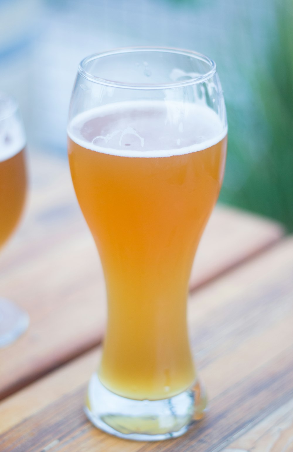 filled clear drinking glass on top of table