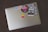 A colorful laptop covered in various stickers and decals.