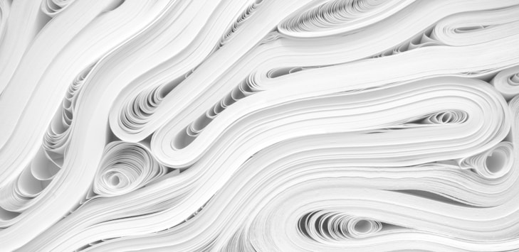 side picture of a pile of white paper forming a texture like pattern together