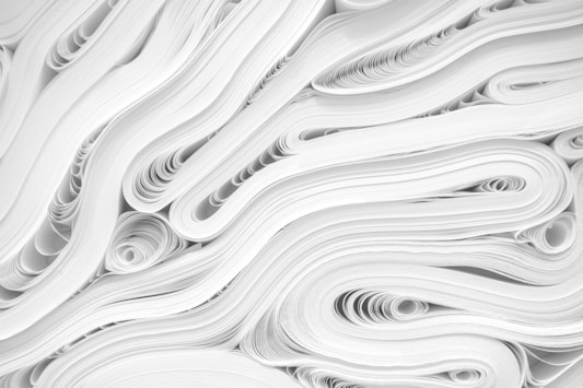side picture of a pile of white paper forming a texture like pattern together