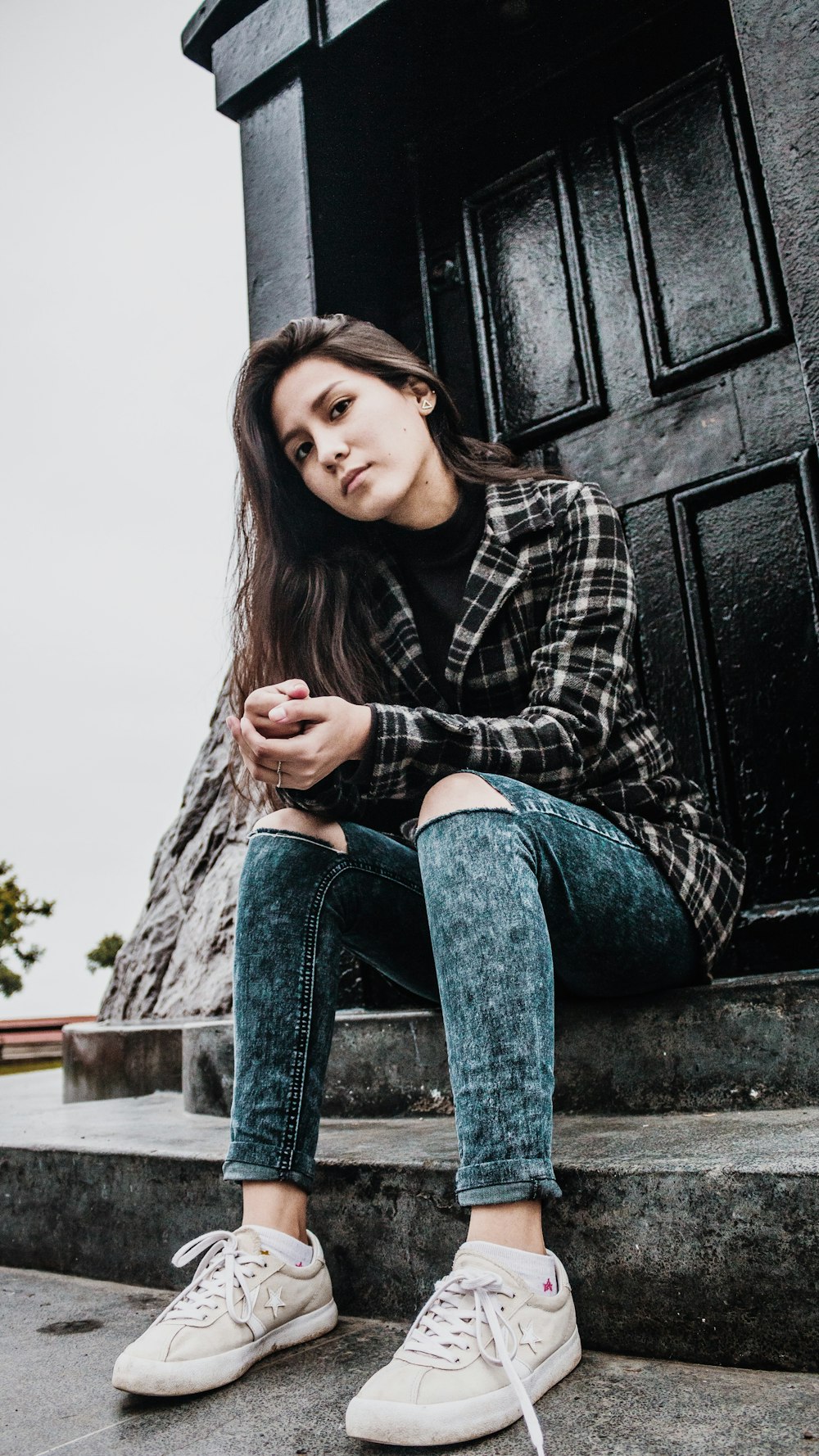 woman sitting in front of door