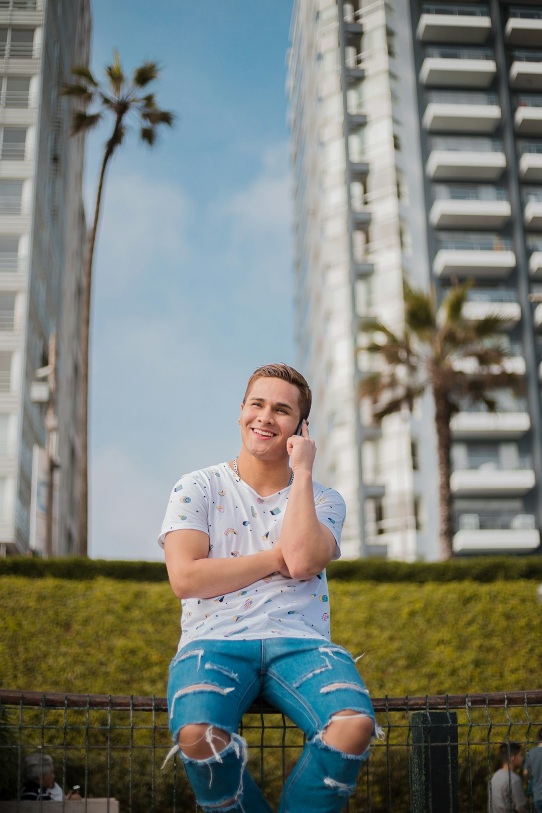 smiling man sitting on metal screen