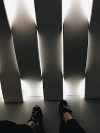 A model wearing the shoes in a casual office setting, highlighting their dual-purpose appeal.
