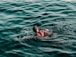 man swimming on water