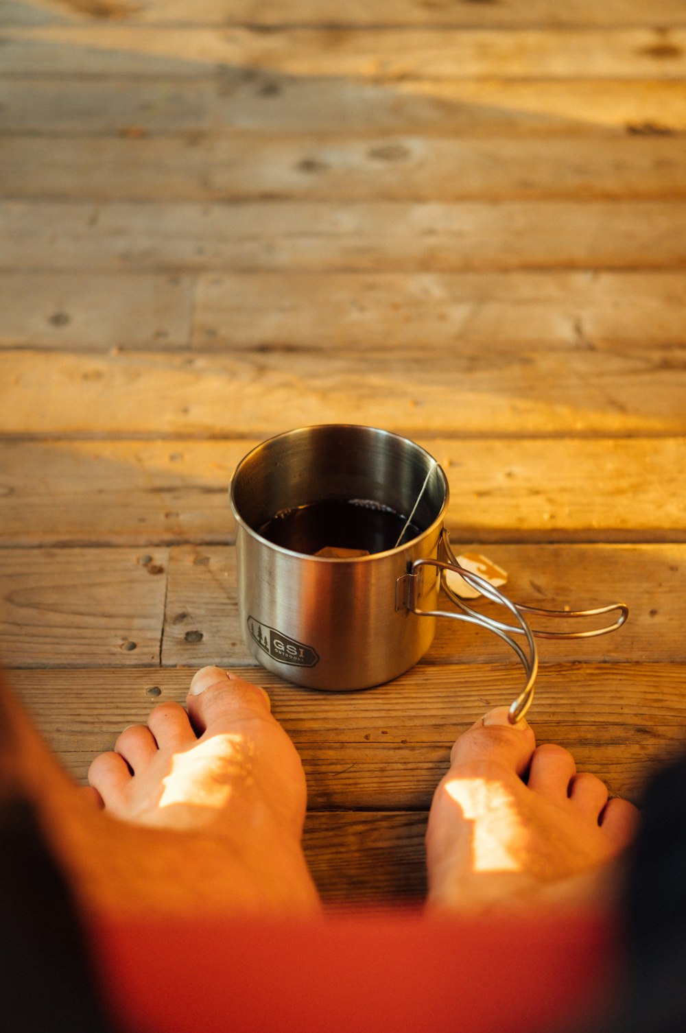 silver cup on brown wooden surface