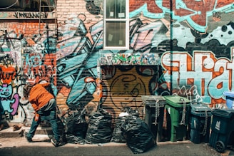 Team removing graffiti from a city wall as part of environmental upkeep.
