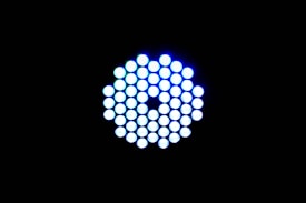 A circular arrangement of small, brightly lit LED lights against a black background. The LEDs emit a cool blue-white light and are tightly packed in a symmetrical pattern.