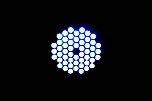 A circular arrangement of small, brightly lit LED lights against a black background. The LEDs emit a cool blue-white light and are tightly packed in a symmetrical pattern.