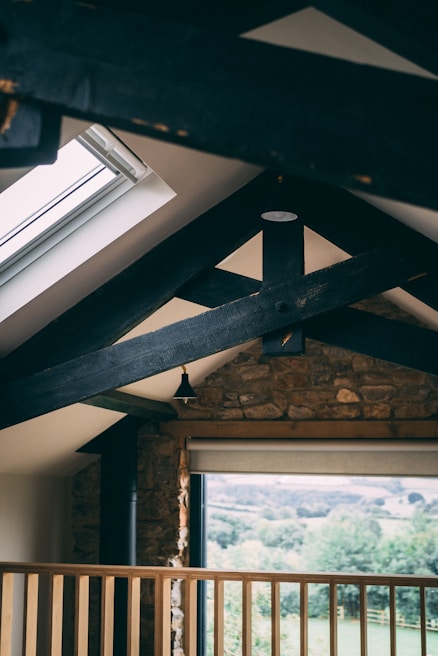 Cozy interior of the Antica Veglie monolocale with rustic wooden beams and soft natural light.