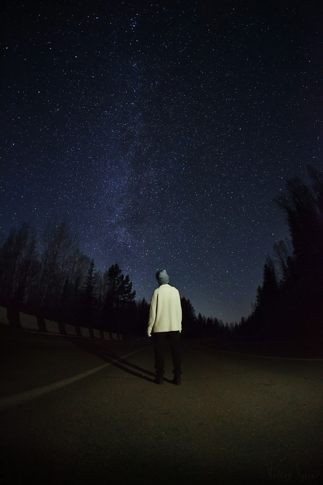 man standing on road