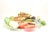 A plate of sliced stuffed flatbreads is presented, garnished with fresh green basil leaves, lime slices, and tomato slices. The filling appears to be a mixture of spiced vegetables and possibly meat, with visible colors and textures suggesting a flavorful composition.