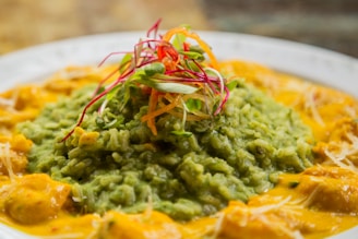 A vibrant plate of chicken curry garnished with fresh herbs.
