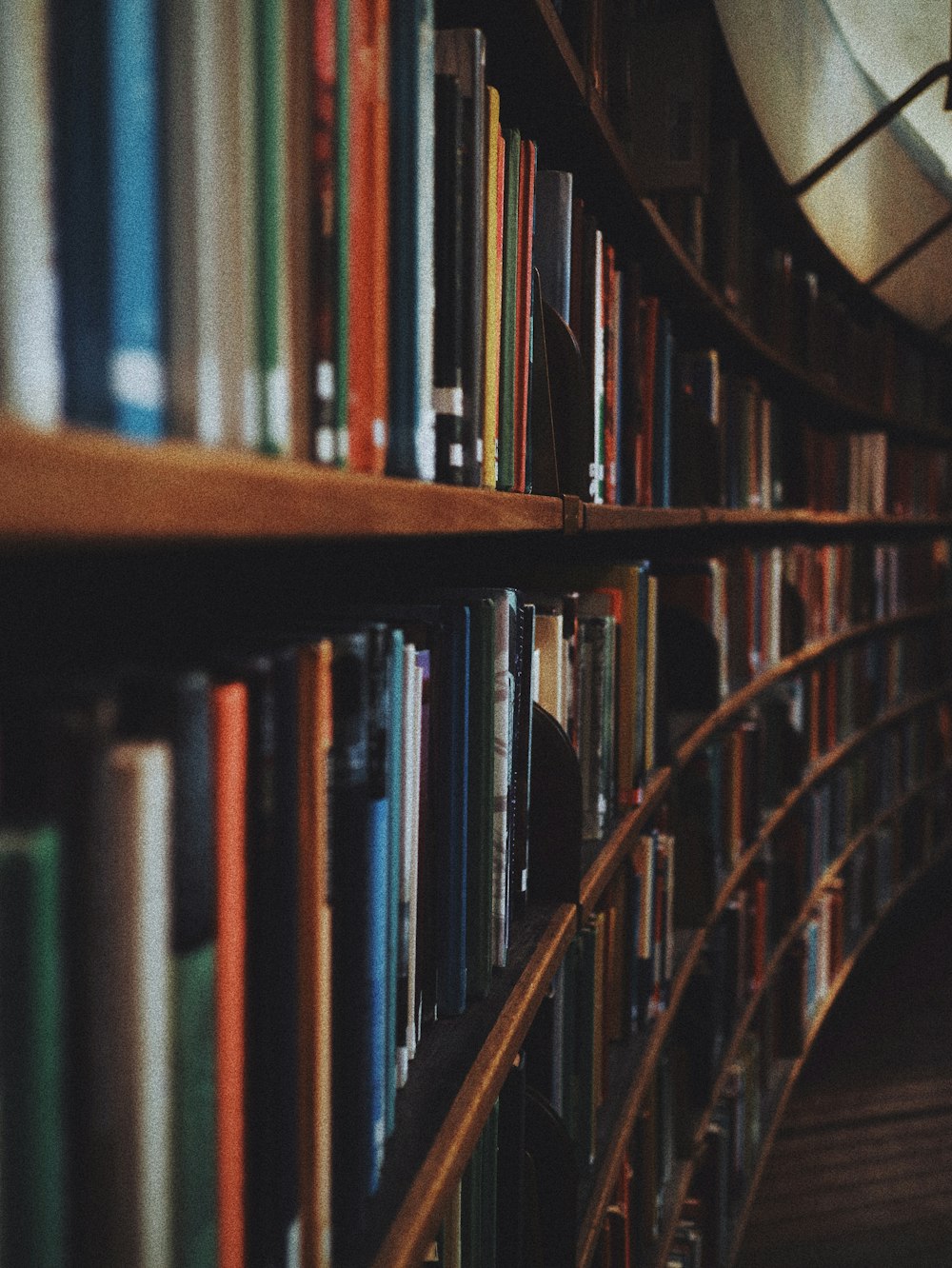 a bookshelf filled with lots of books next to a clock