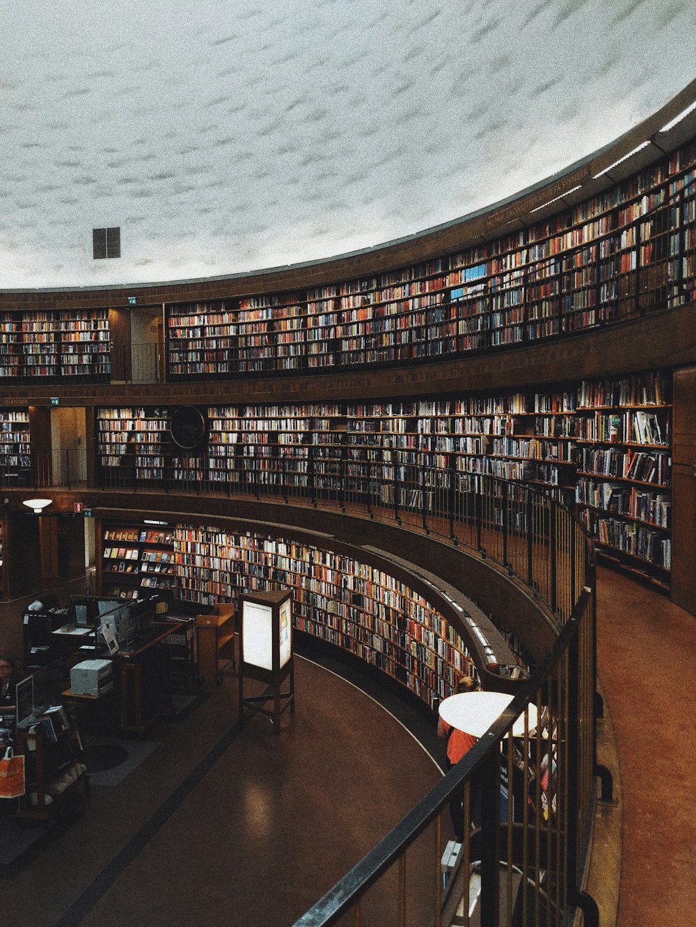 a library filled with lots of books under a cloudy sky