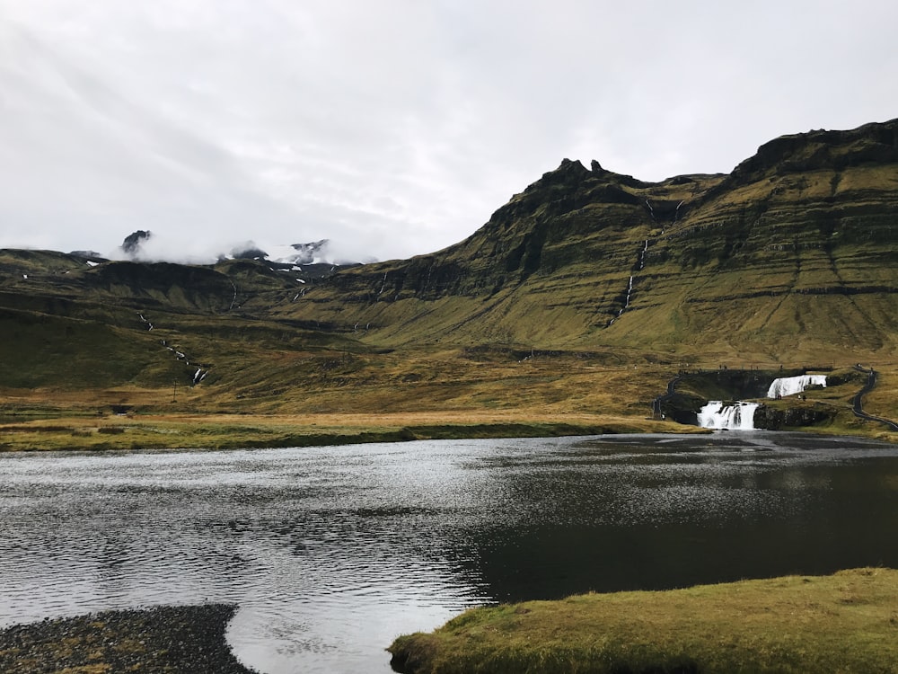 body of water beside mountain