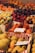 A variety of fresh fruits are neatly arranged in boxes at a market. The selection includes citrus fruits, apples, plums, figs, and peaches. Each box is labeled with handwritten signs displaying prices or names. The scene is colorful and vibrant, highlighting the abundance of fresh produce available.