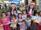 Volunteers distributing educational materials to children in a vibrant neighborhood setting.