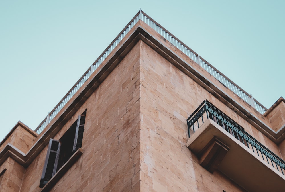 low angle photography of brown painted building