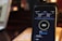 A smartphone screen displaying an internet speed test app, showing download and upload speeds of 0.47 MB/s and 0.31 MB/s respectively. The background is blurred, potentially showing a dim environment with warm lighting.
