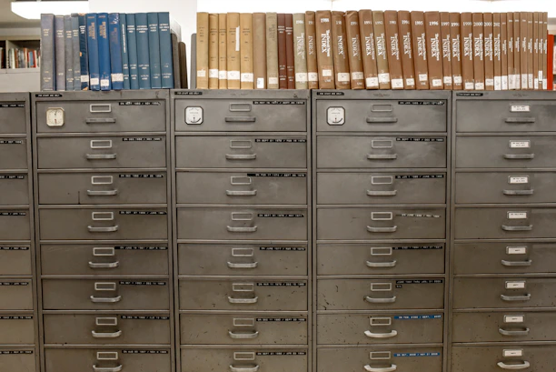 A neat row of sturdy metal filing cabinets in an office setting.