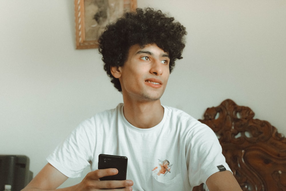 man holding black smartphone