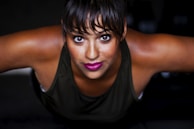 A client mid-pushup, muscles engaged, with a focused expression under moody gym lighting.