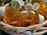 A collection of empty orange prescription pill bottles with white childproof caps is inside a worn wicker basket. Each cap displays various pharmacy labels and instructions. The surrounding setting is dimly lit, highlighting the details on the bottles and basket.