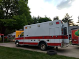Ambulance parked outside a community center ready for emergency response.