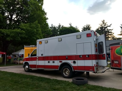Ambulance parked at a sports event with medical staff preparing equipment.