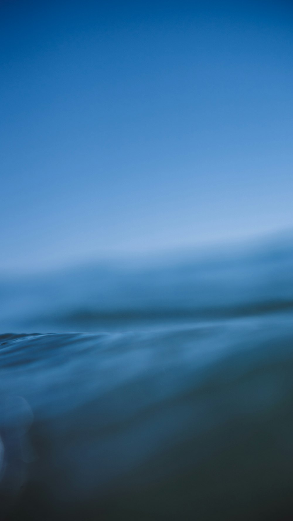 a person riding a surfboard on a wave in the ocean