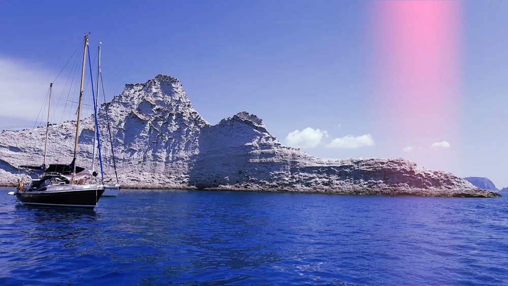 white sailboat near island