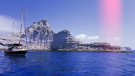 white sailboat near island in Palmarola Italy