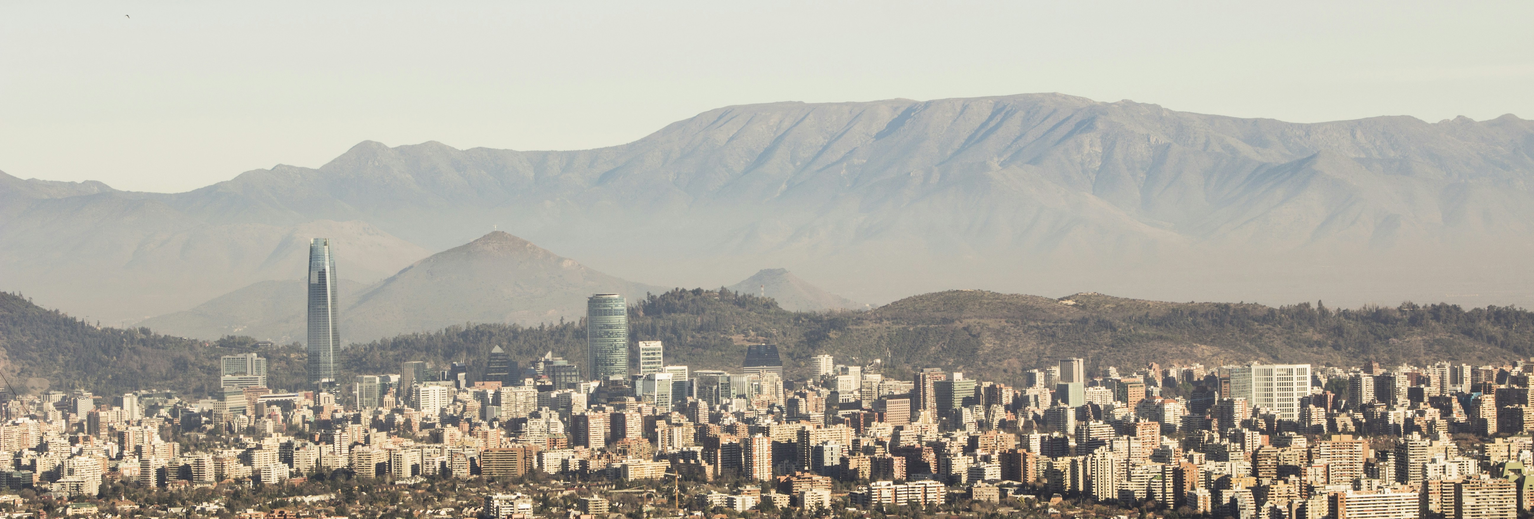 white and gray concrete buildings, Santiago de Chile from the Andes. Last sunday, hiking with two friends at the beginning of the Andes Mountains. In this photograph you can see Las Condes and Vitacura districts.