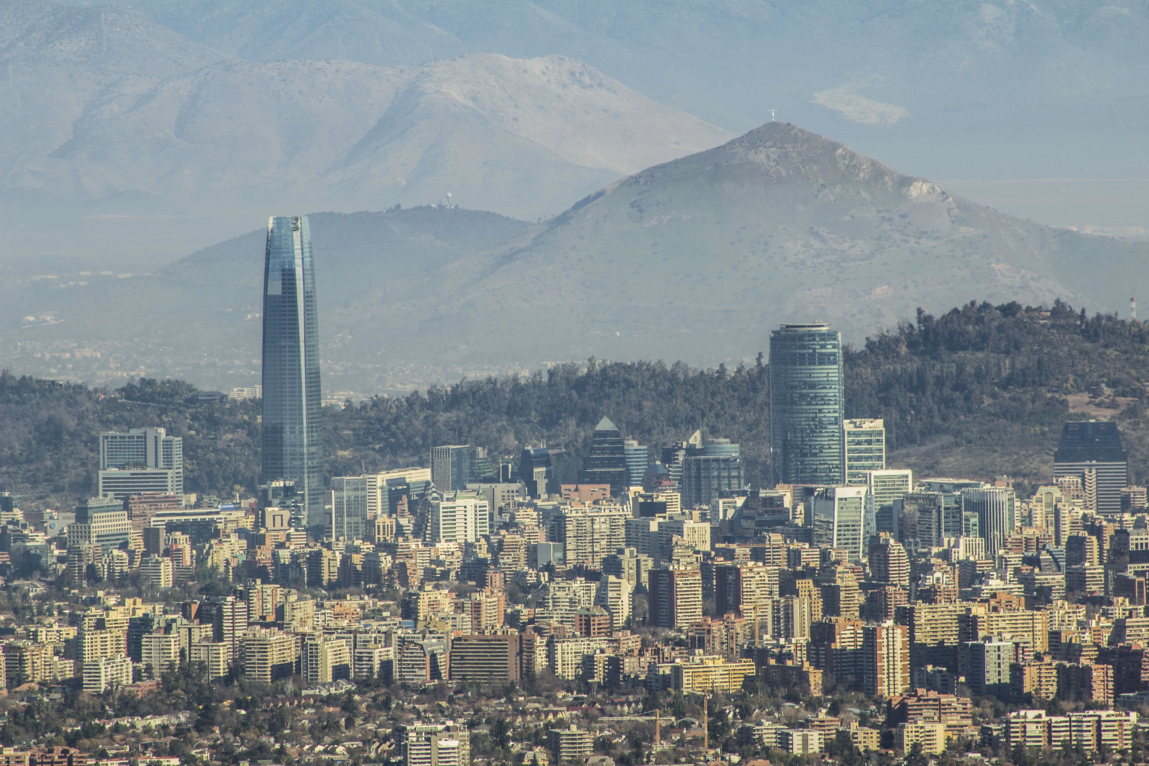 Santiago's towers rising in front of the snow line of the Andes