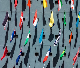 photo of assorted-color nation flags on wall during daytime