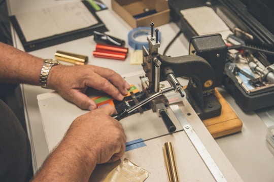 shallow focus photo of person sewing