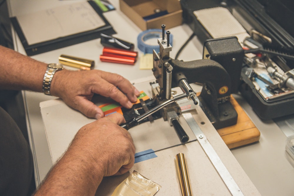 shallow focus photo of person sewing