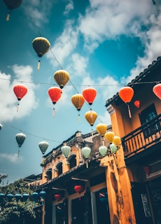 Colourful lanterns hanging above a street in an ancient Vietnamese town