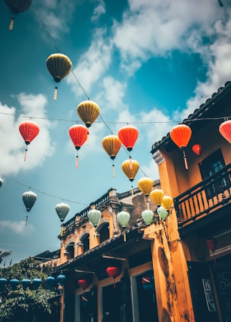 Colourful lanterns hanging above a street in an ancient Vietnamese town