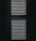 Vertical window blinds are partially opened, casting dramatic shadows and light patterns with strong contrast.