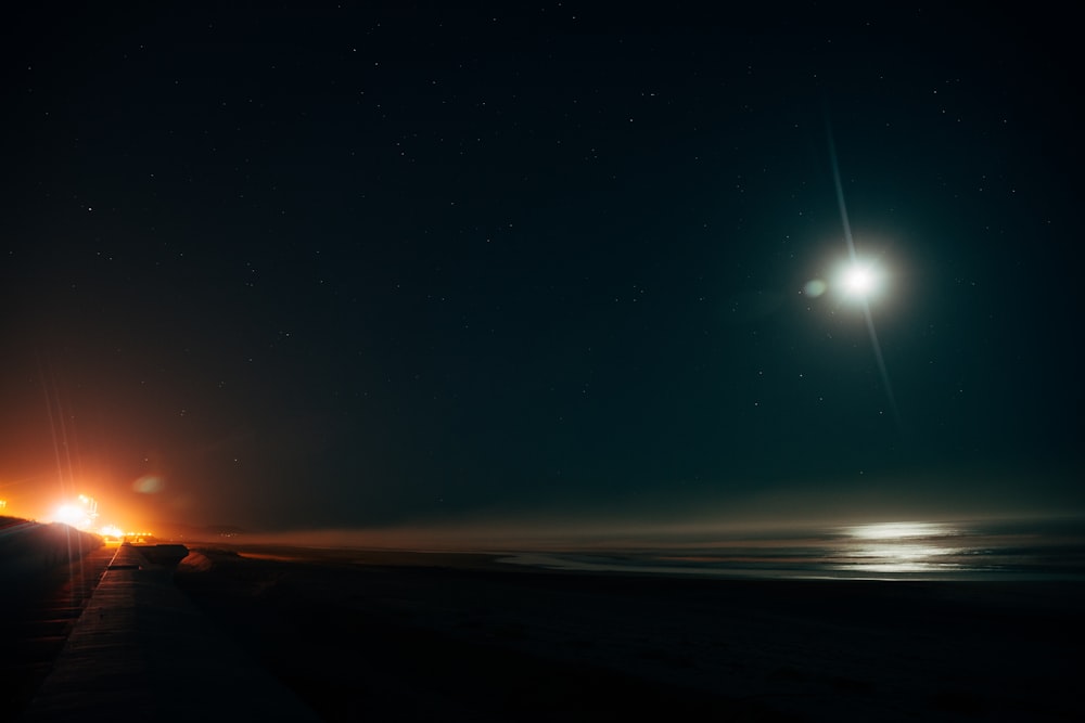 a car driving down a road at night