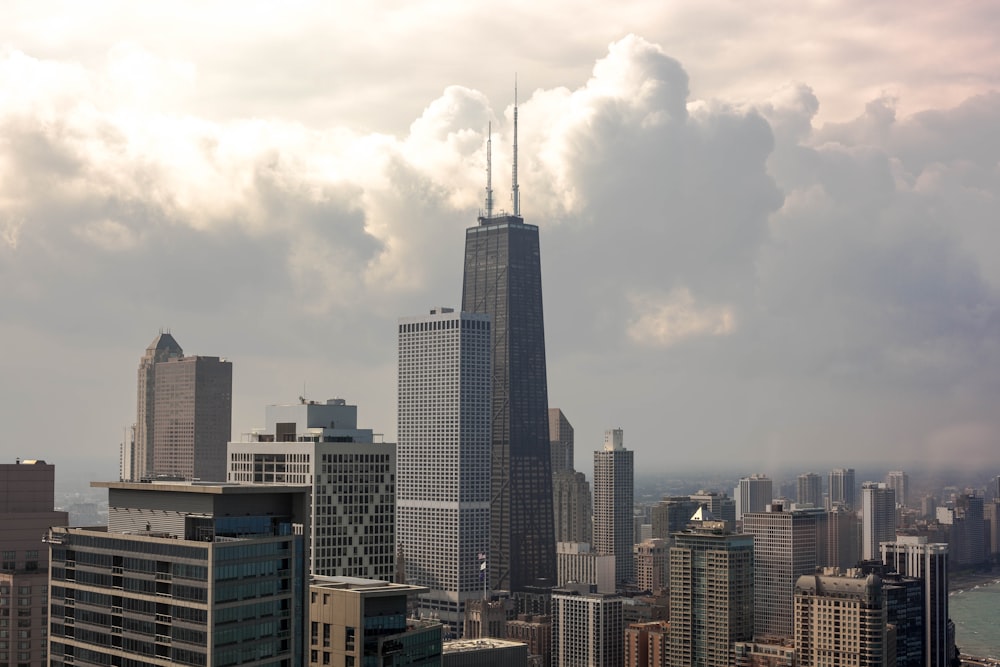 high rise building under cumulus clouds