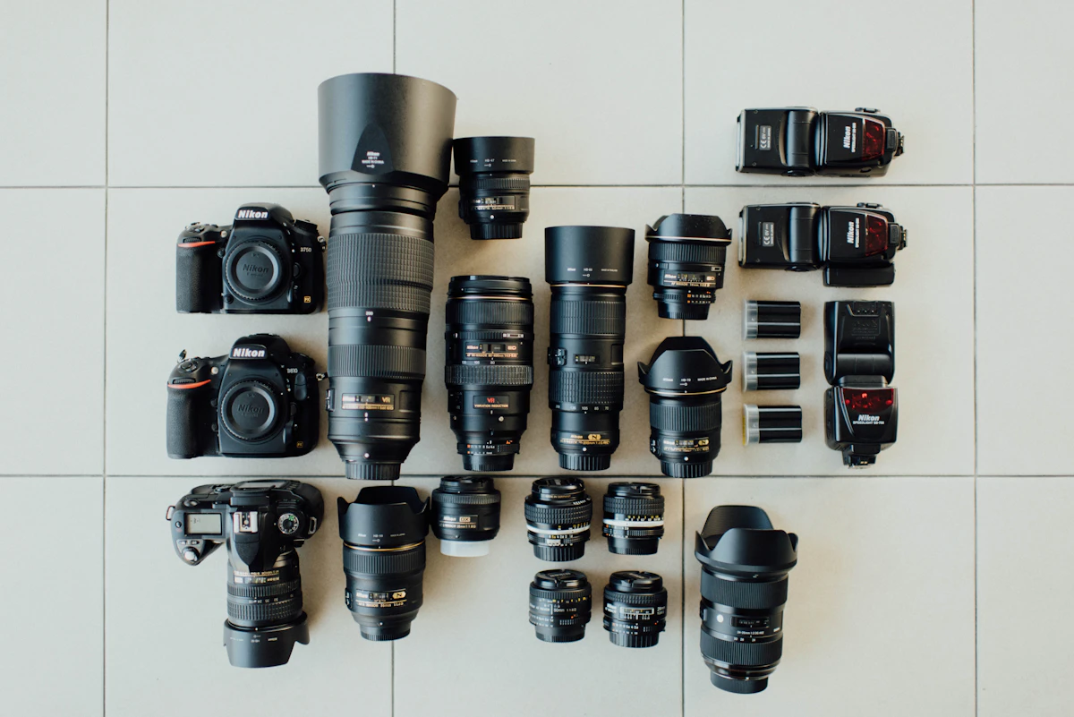 Flat lay of a DSLR camera and lenses arranged on a desk, set up for content creation and photography