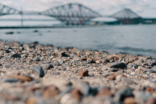 rock lot near body of water and bridge during daytime in Queensferry United Kingdom