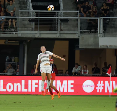 Soccer player striking the ball during a match.