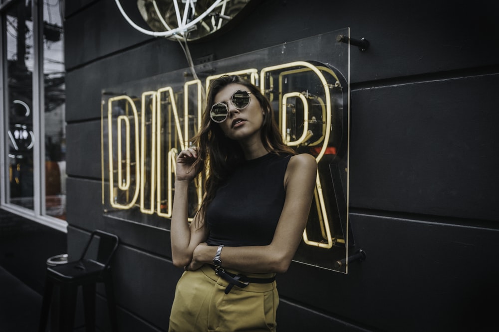 woman standing in front of Diner neon signage