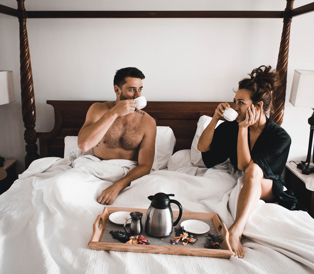 man drinking some coffee beside woman