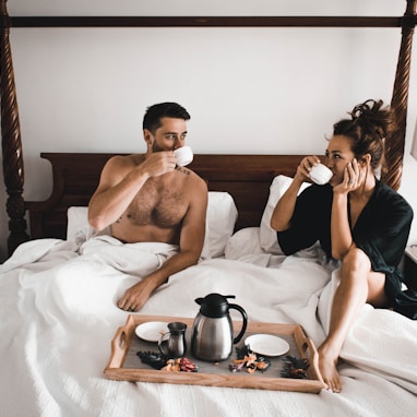 man drinking some coffee beside woman