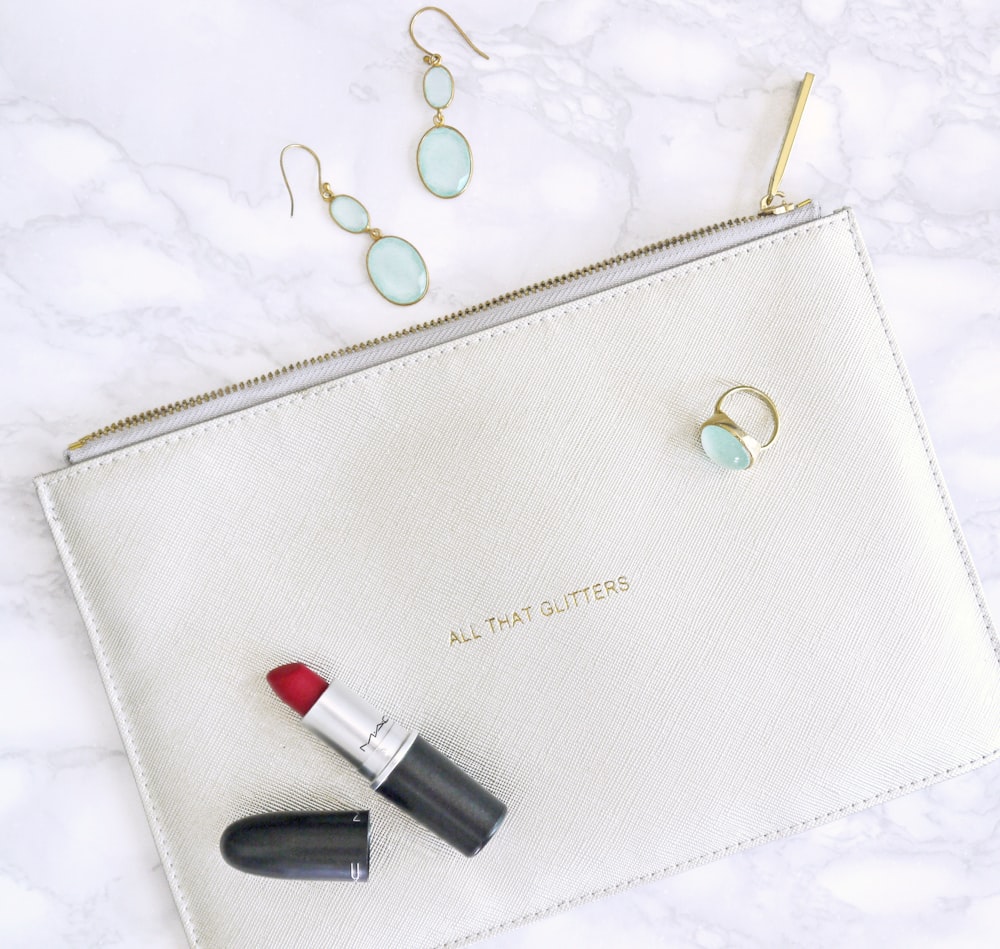 red lipstick, white leather bag, and earrings