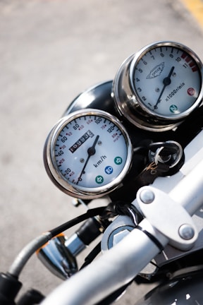 selective focus photography of motorcycle speedometer